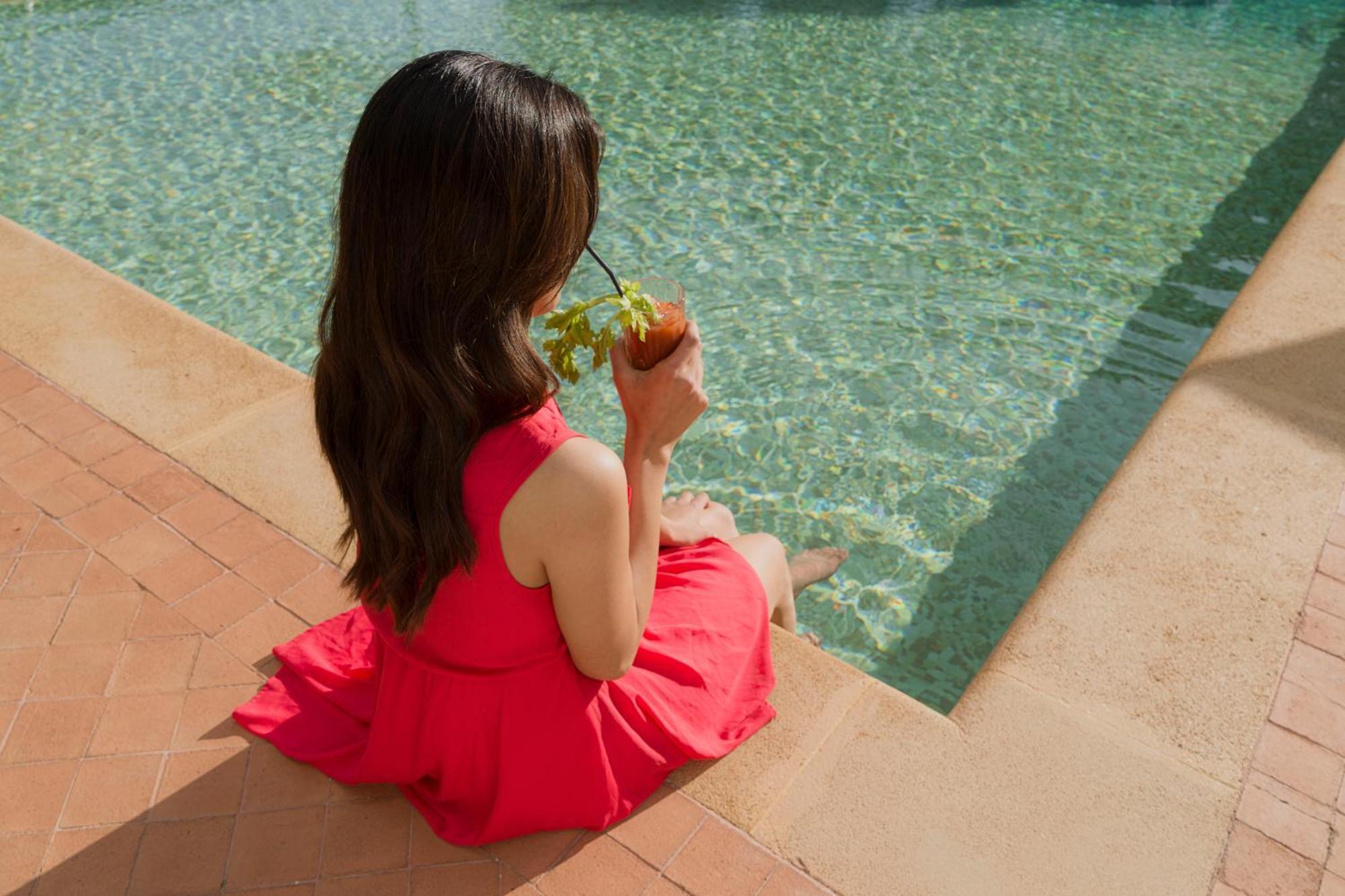 Villa Athena Resort Agrigento Bagian luar foto A woman sitting by a pool